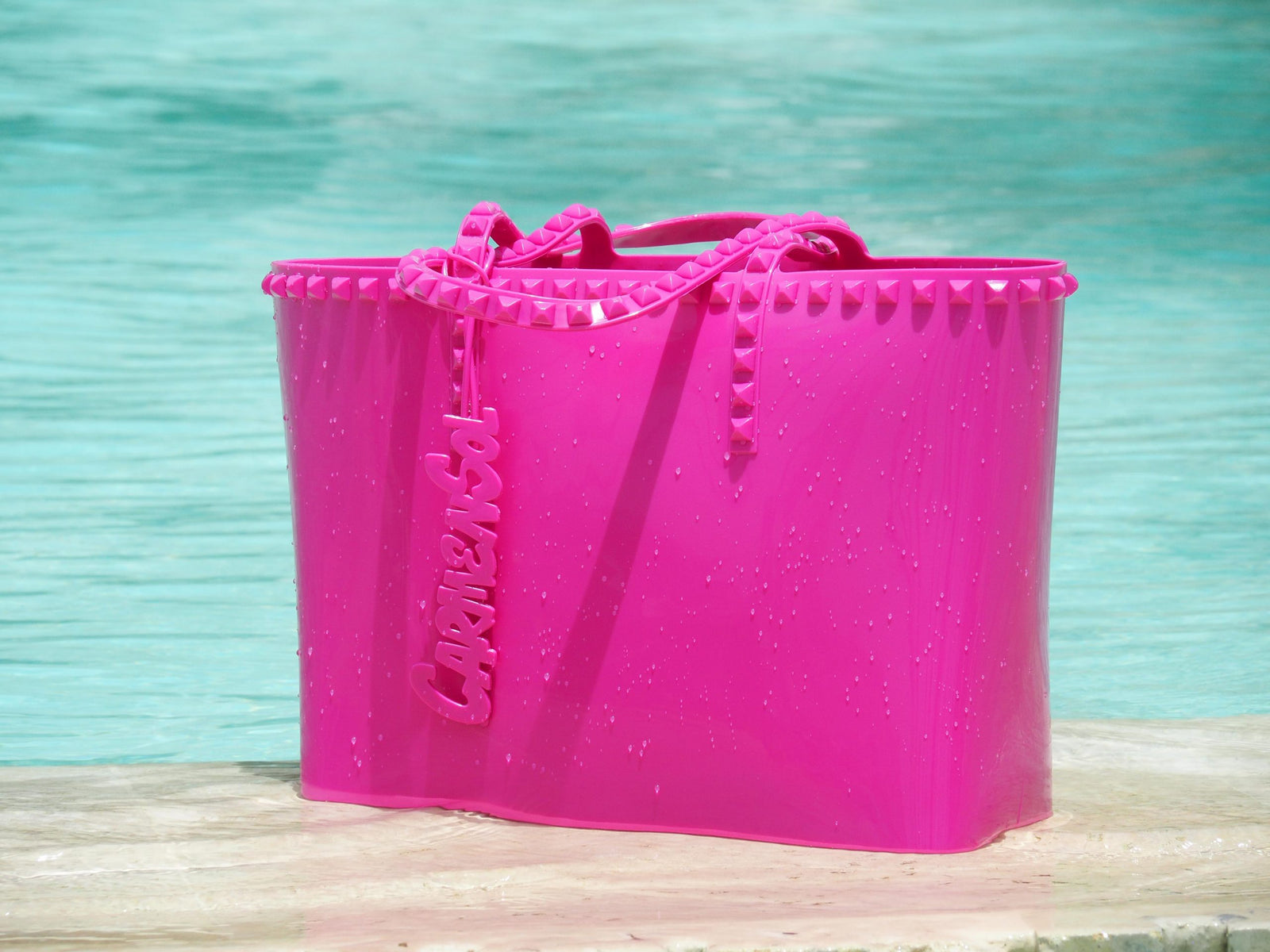 Waterproof Carmen Sol studded beach bags for women in color fuchsia