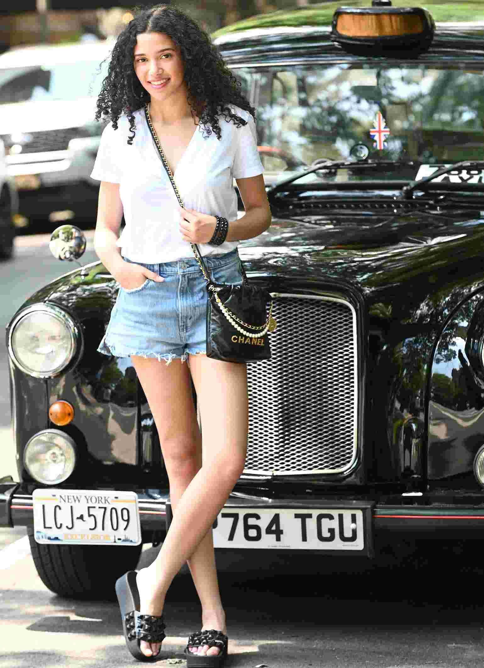 Girl wearing Black in color Carmen platform slides sandals, Jelly bracelets attractive street lovers accessories made in Italy.