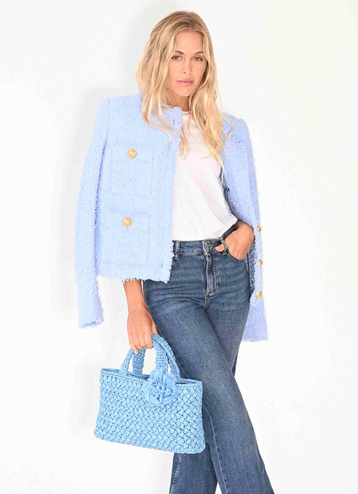 Women carries Baby blue Positano Raffia tote Bag from Carmen Sol, Italia collection