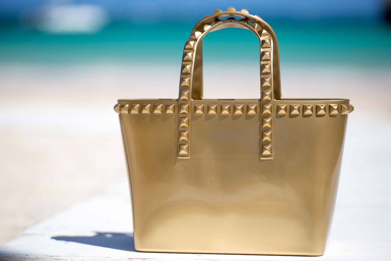 Carmen Sol studded mini jelly beach purse in color gold