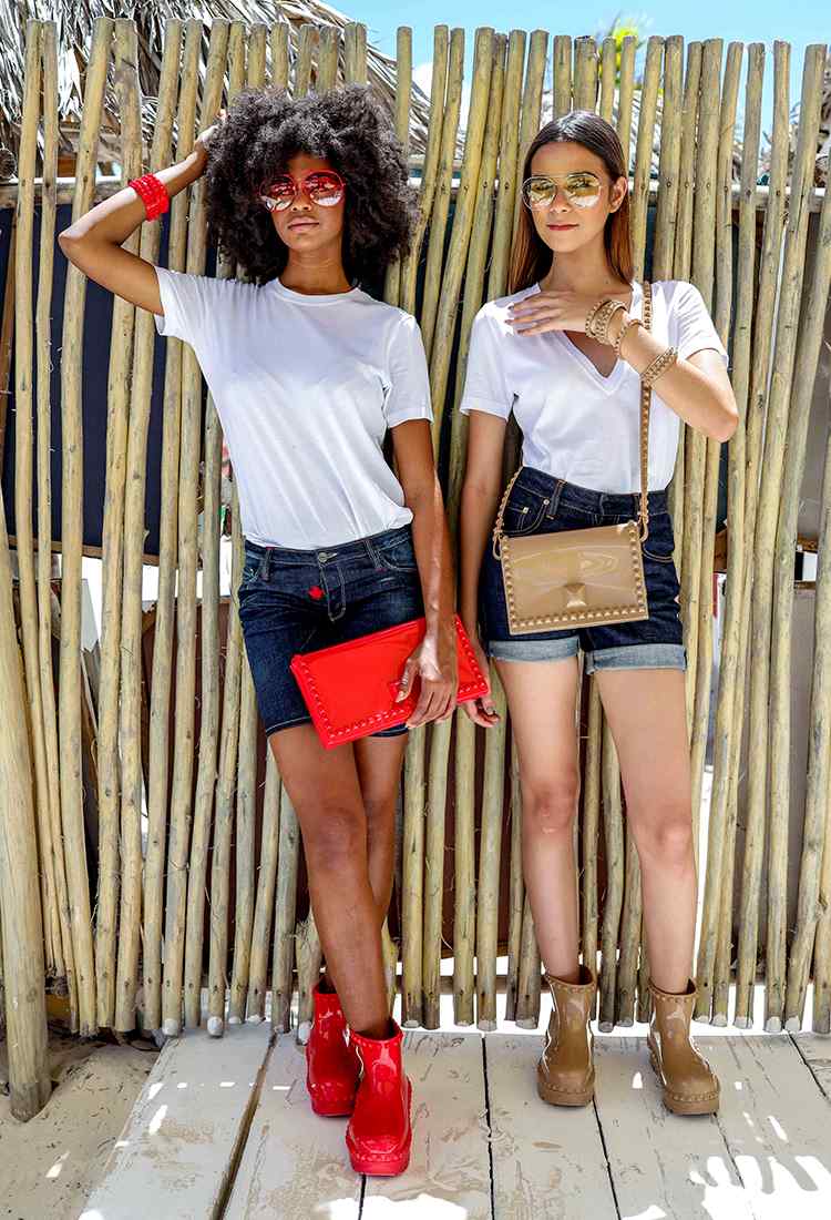 2 girls wearing Carmen Sol aviator sunglasses one in nude and one in red with matching puddle boots and jelly bags