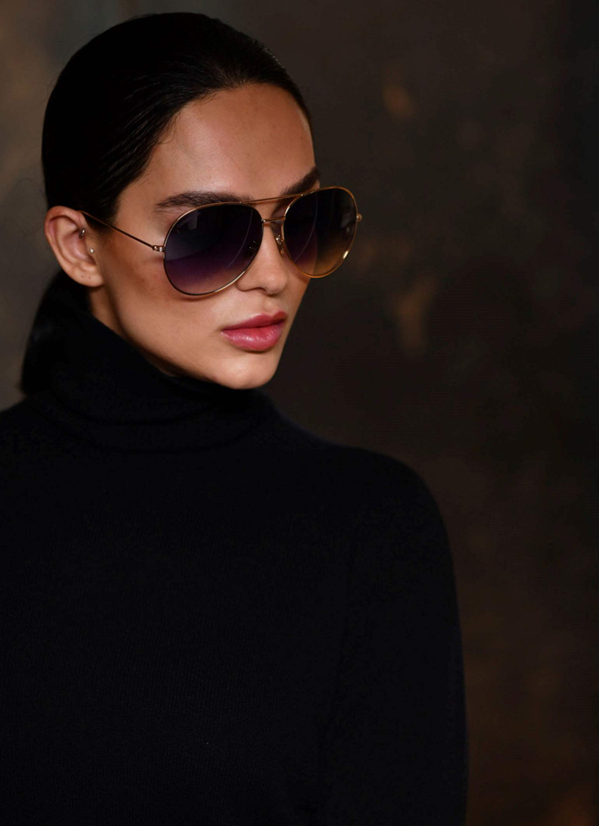 Women wearing made in Italy turtleneck cashmere cardigan in color black with matching Carmen Sol sunglasses