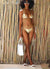 WomWomen in bathing suit wearing white sandals 3 straps jelly slides with matching jelly bags