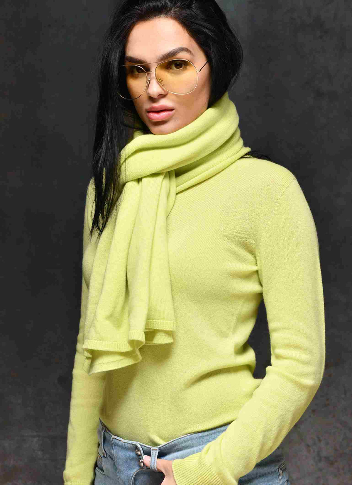 Sunglasses for women in color gold worn with yellow cashmere sweater and matching scarf