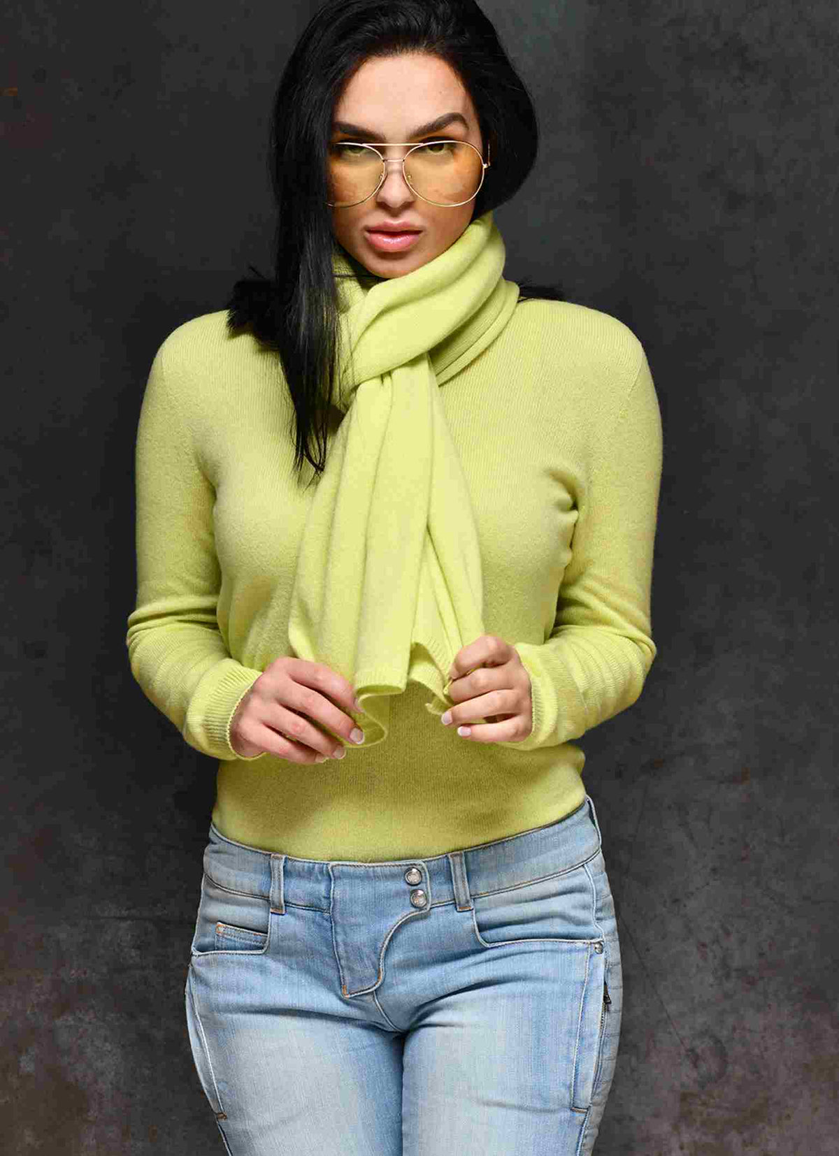 Women wearing Carmen Sol cashmere scarf with matching cashmere and sunglasses in color yellow