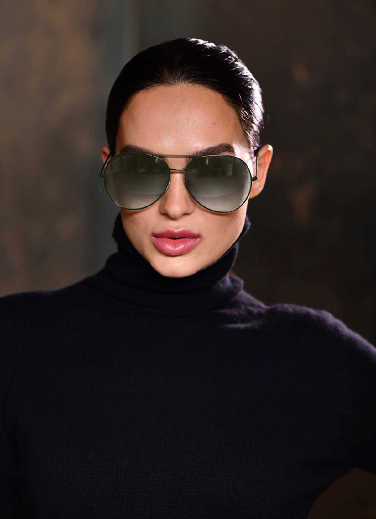 Beautiful girl wearing a pair of olive green aviator sunglasses and black turtle neck pure cashmere sweater