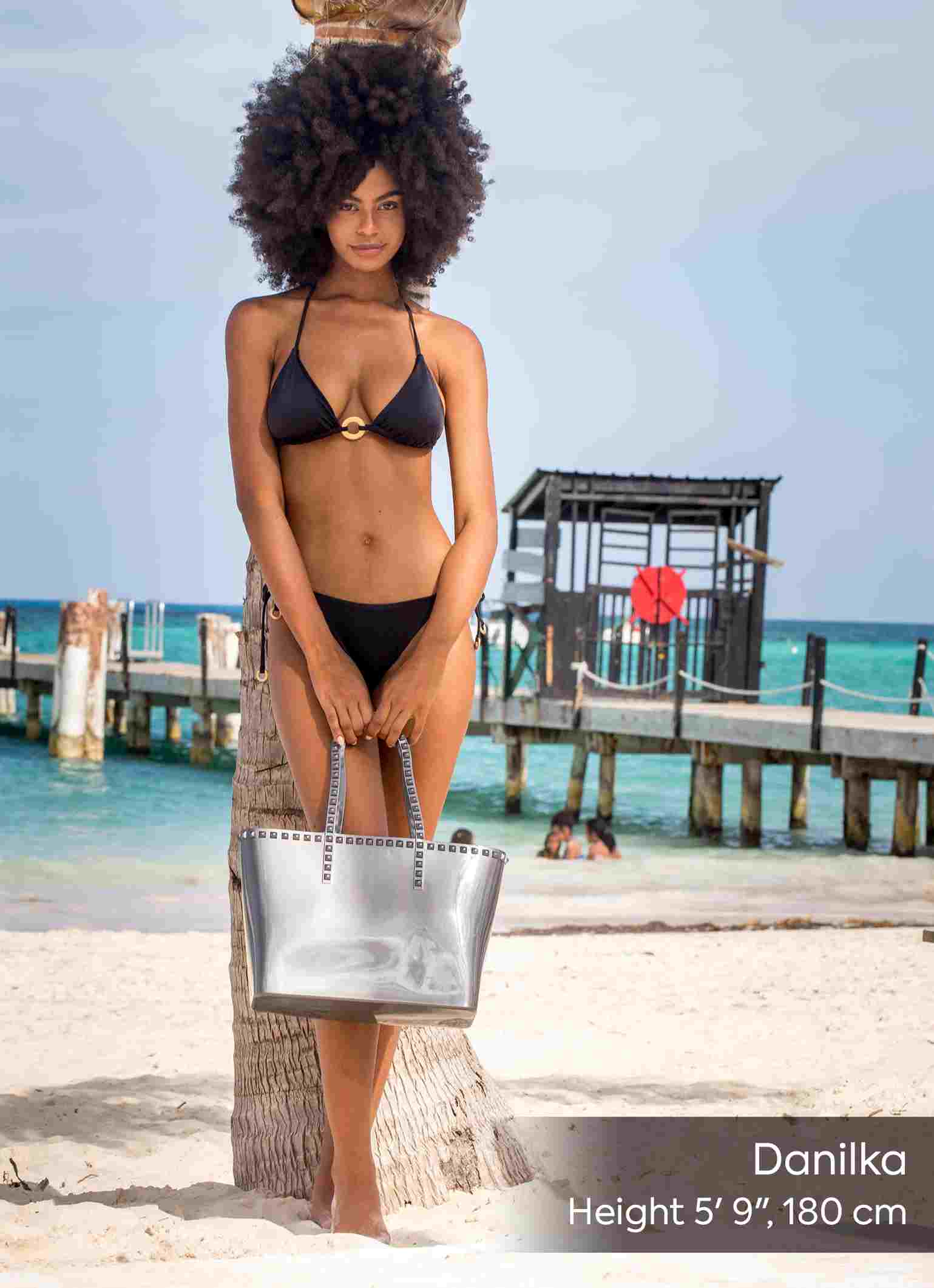 Woman holding Carmen Sol Seba mid jelly tote in color silver