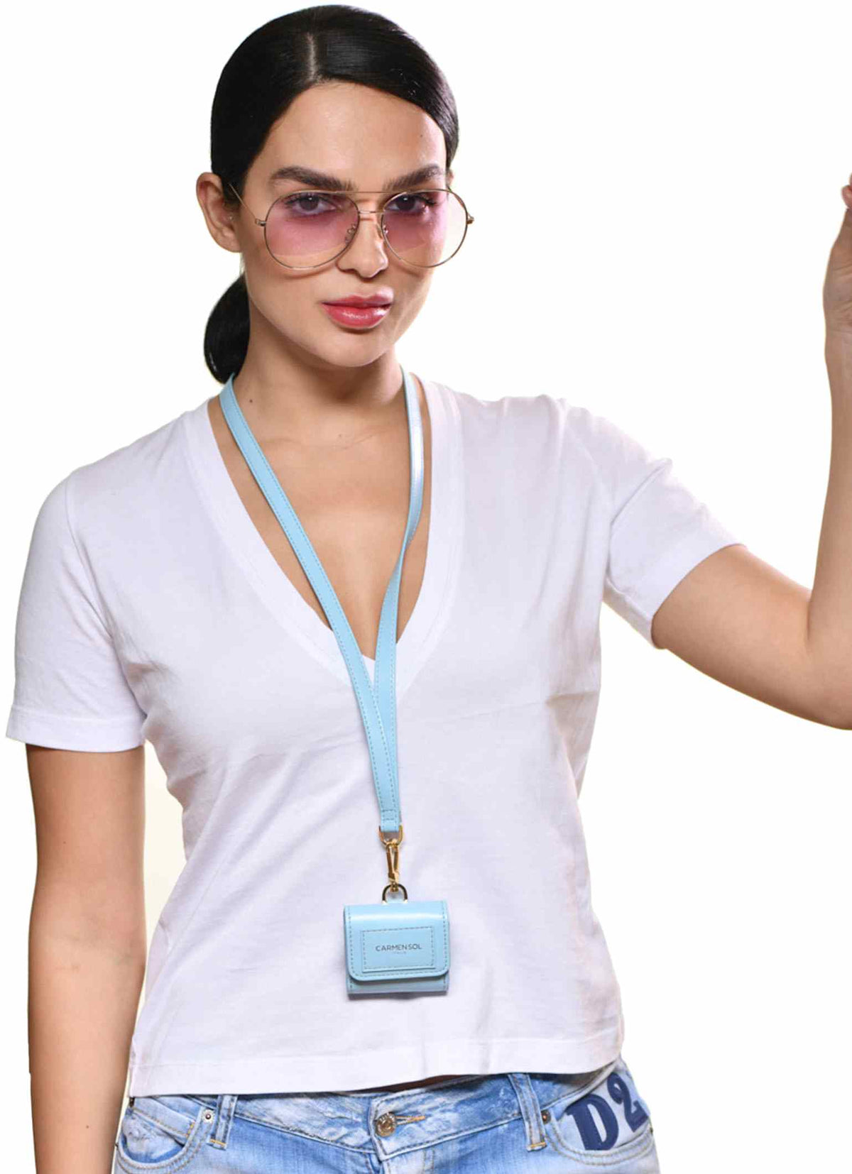 woman wearing Carmen Sol airpod case with sunglasses