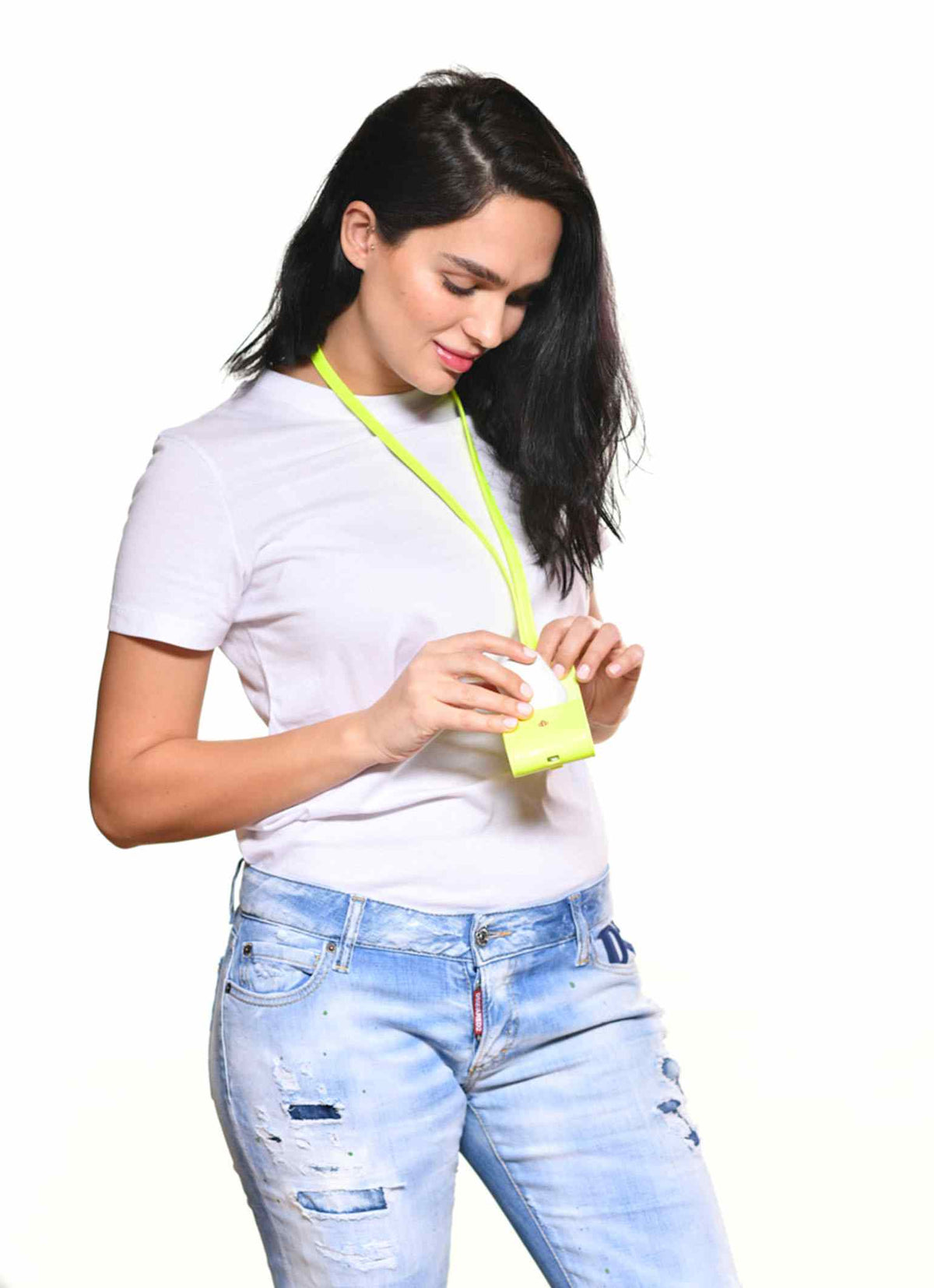 Woman wearing Tommy airpod case in color neon yellow which is perfect for her outfit